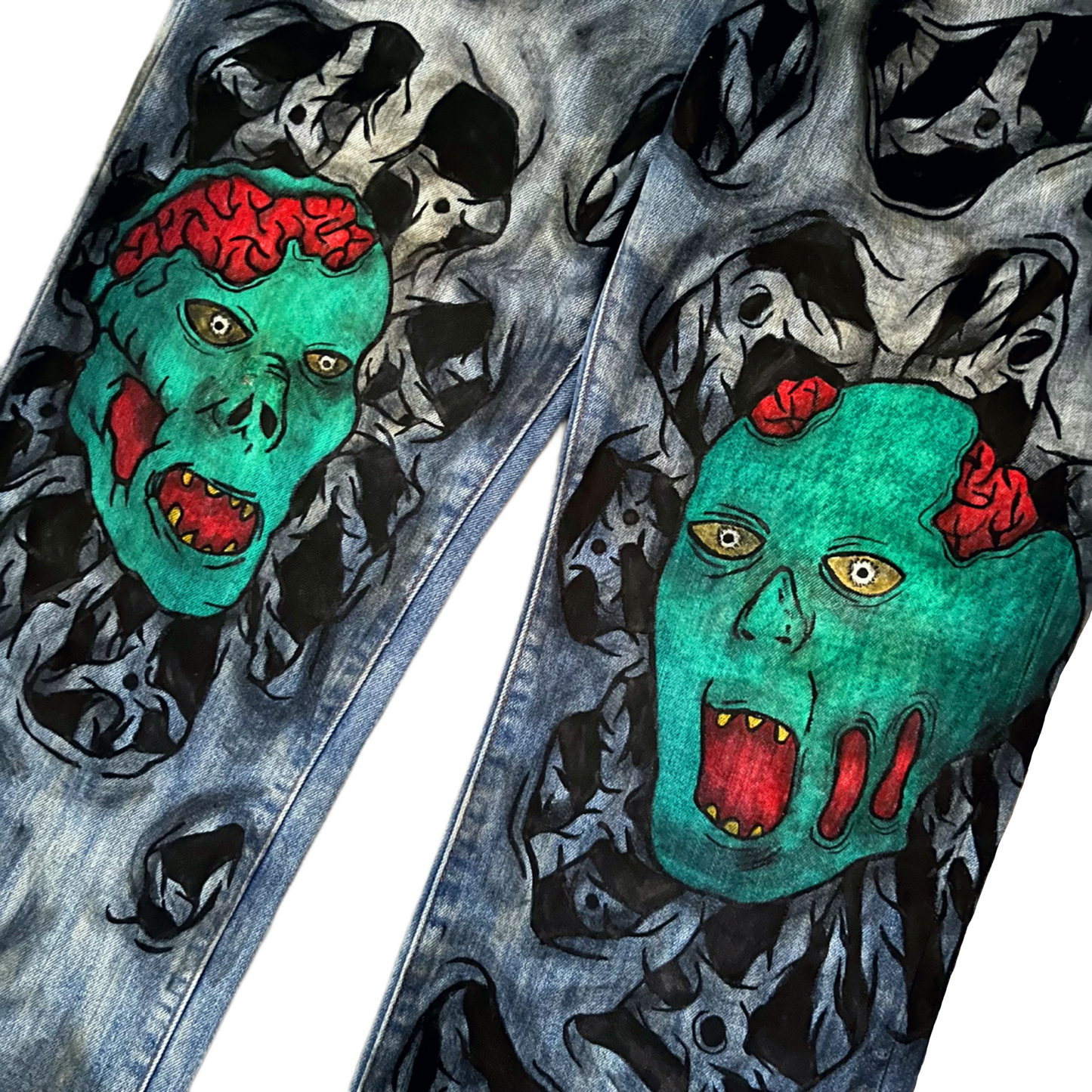 Blue jeans with a green zombie face design