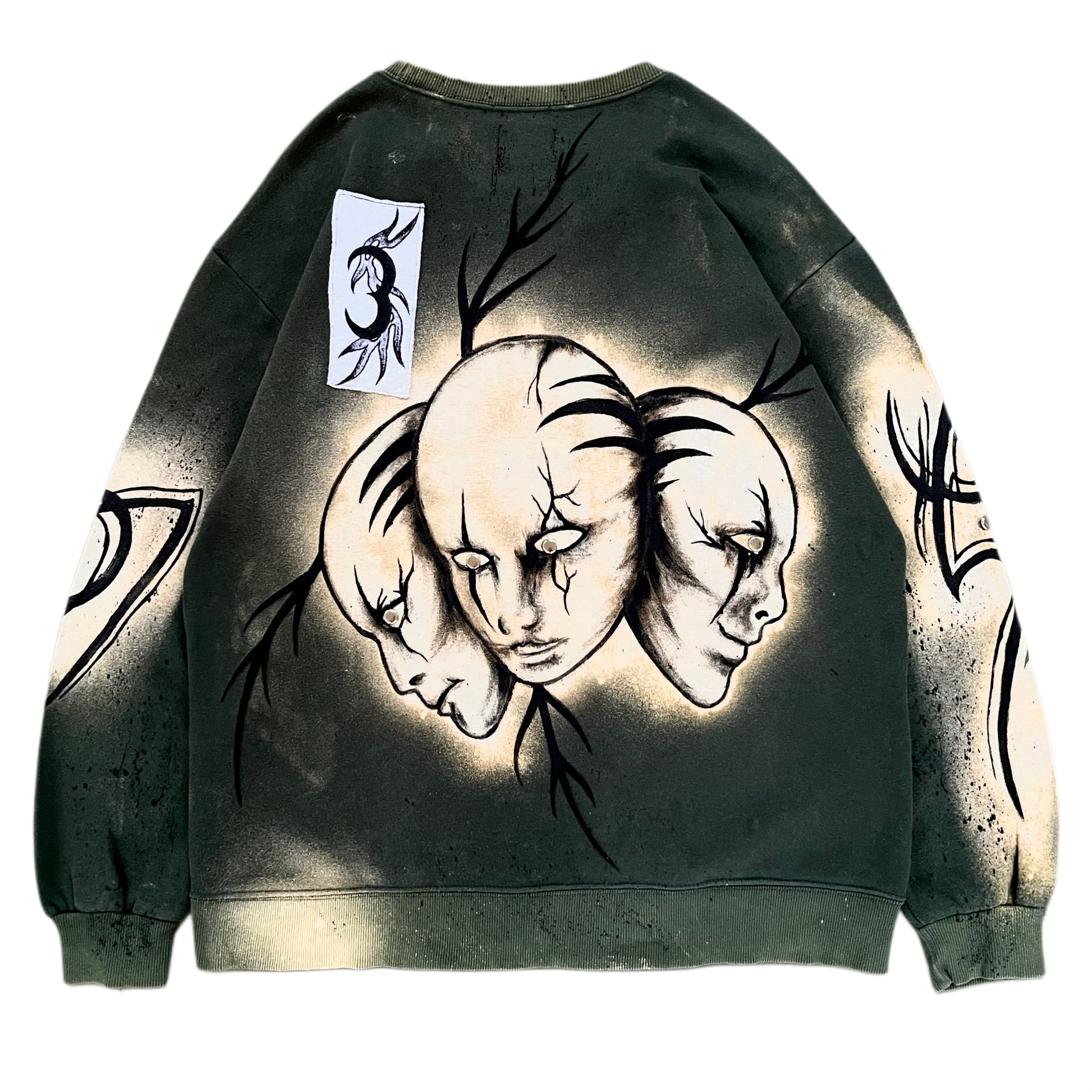 Sweatshirt with artistic design of three faces on a white background