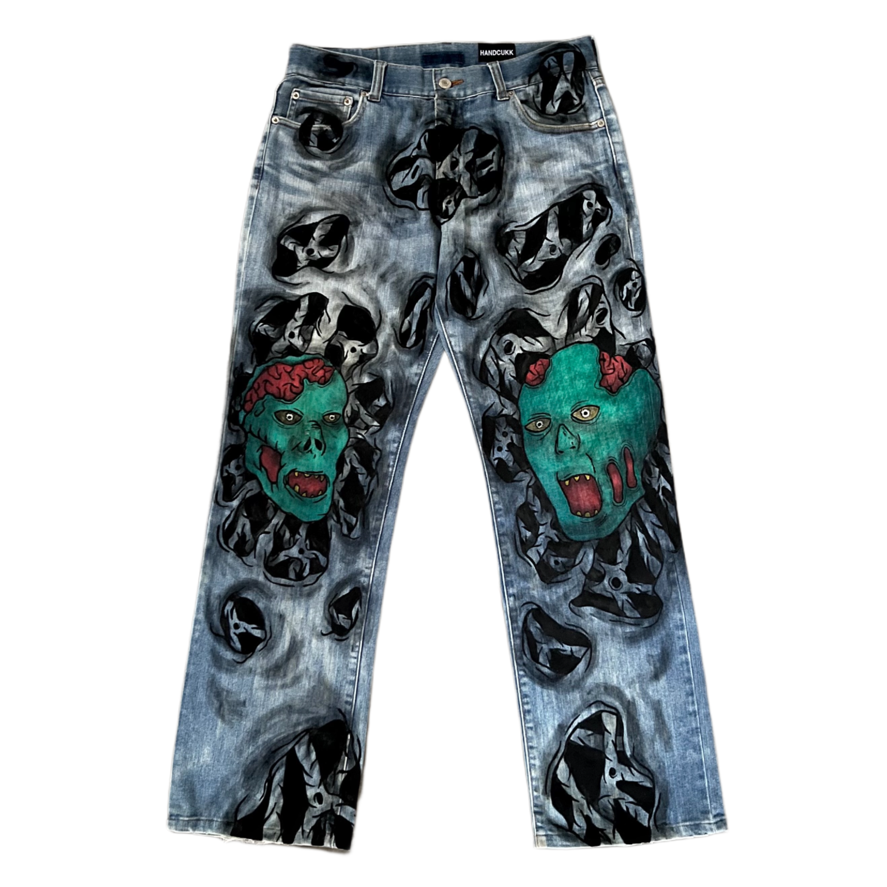 Denim jeans with graphic designs of zombie faces on a white background